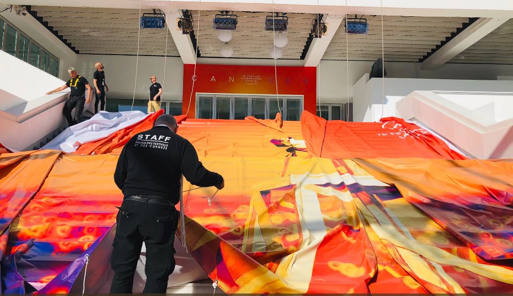 Workers preparing to raise the 2019 banner at Cannes